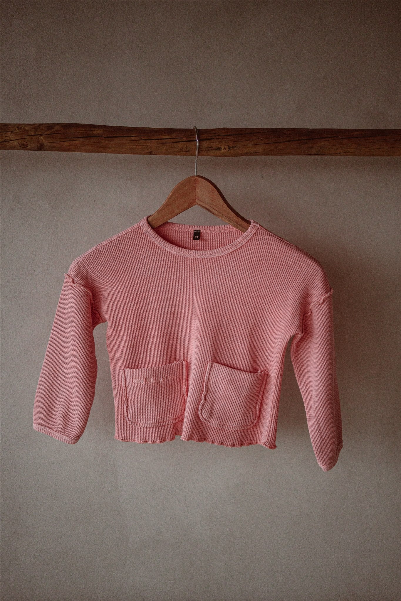Pink sweater made from 100% organic cotton waffle and garment-dyed with natural minerals.