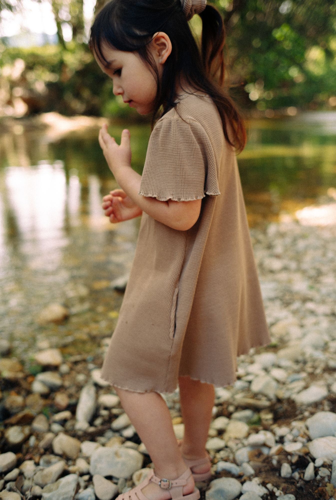River play in Tiny Advocates dress. Made from buttery-soft organic cotton waffle, it is comfortable, stylish and fun to wear. Cute sleeves and functional pockets are a plus.