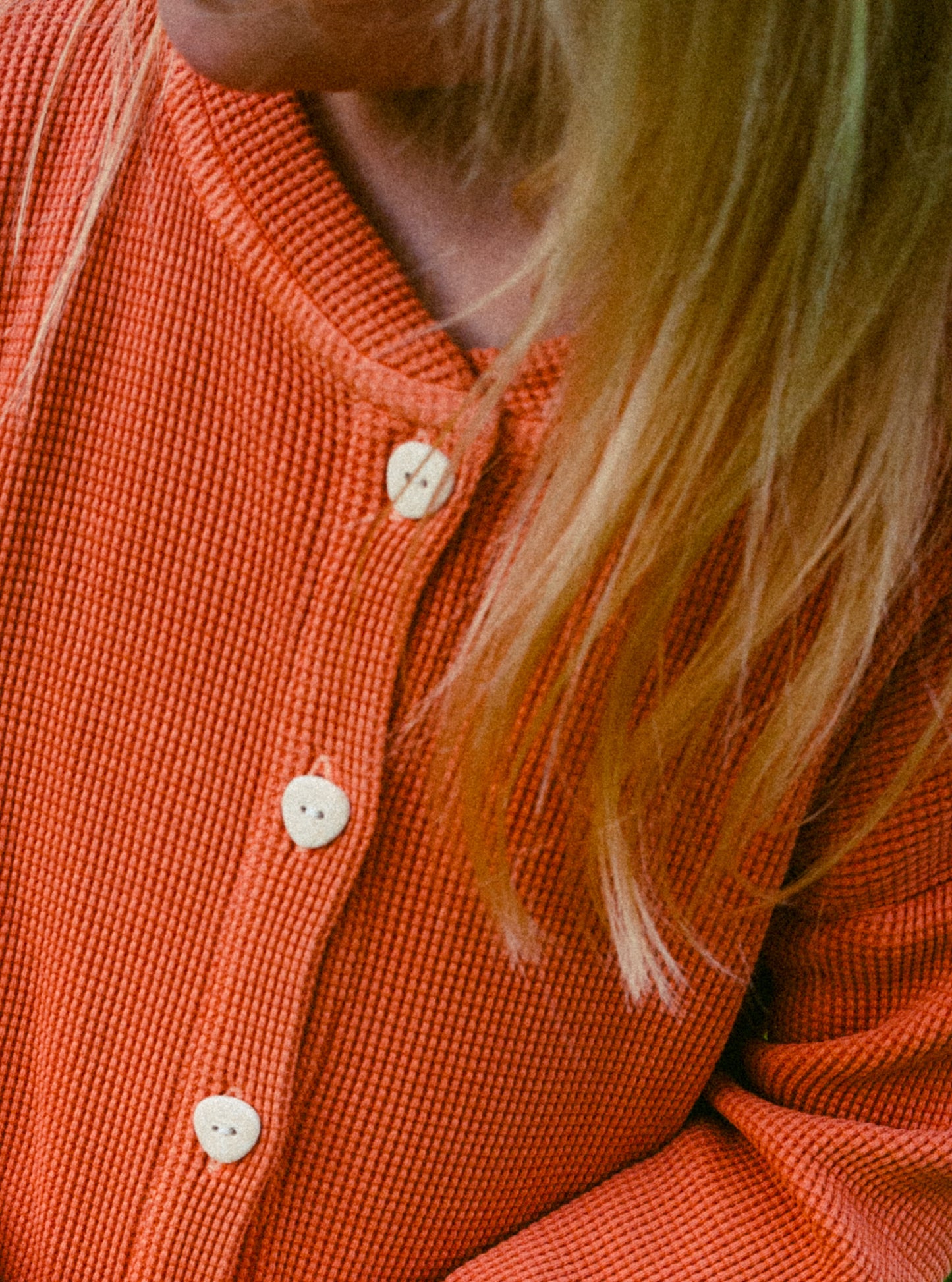 a close up image of a beautiful dress made with 100% organic cotton and garment dyed in natural minerals. It comes with eco friendly buttons and pockets.