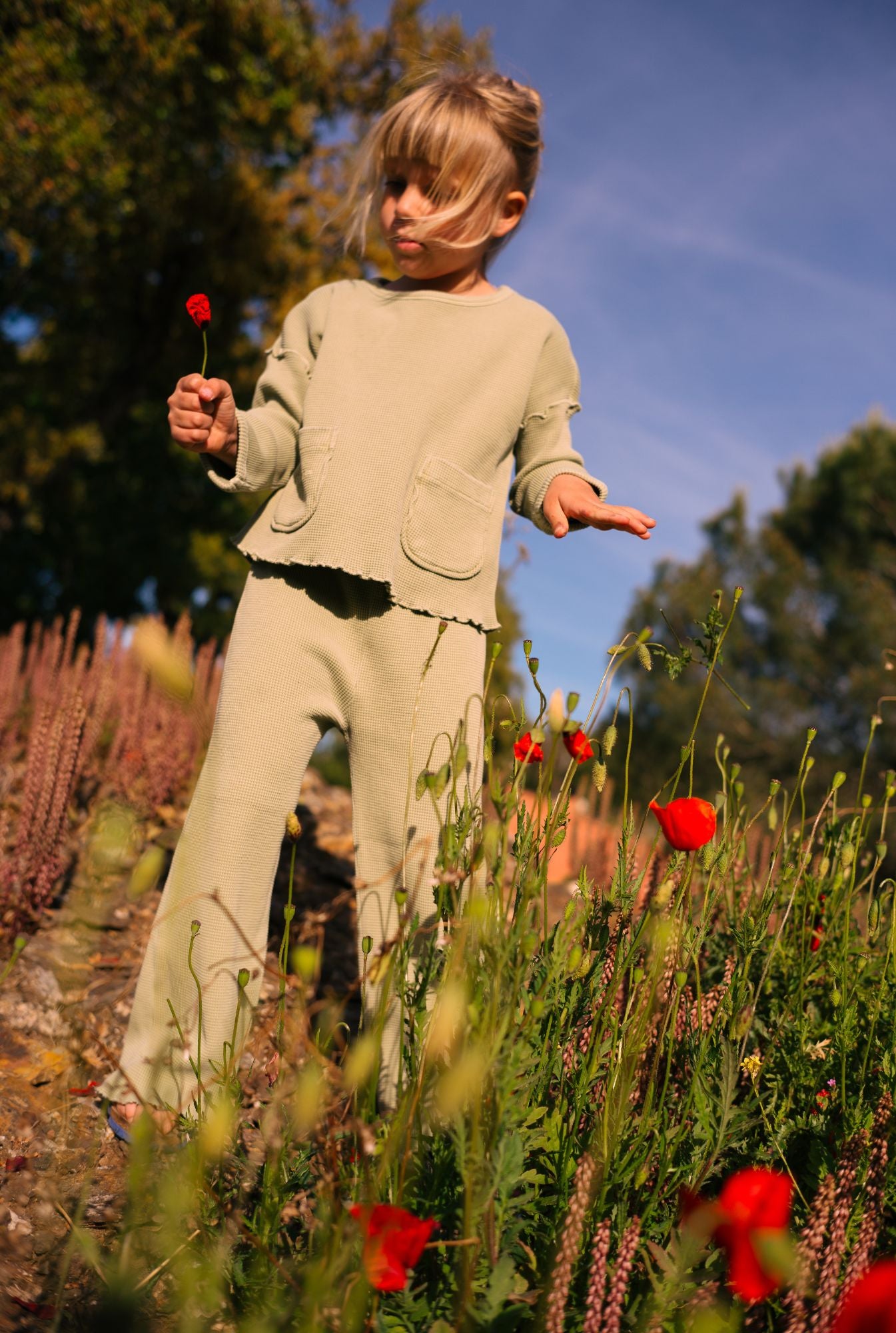 Little girl adventuring in France in her organic cotton waffle set made by Tiny Advocates. 